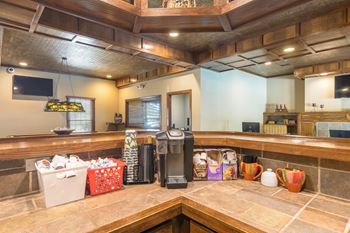A kitchen with a counter and a coffee maker.